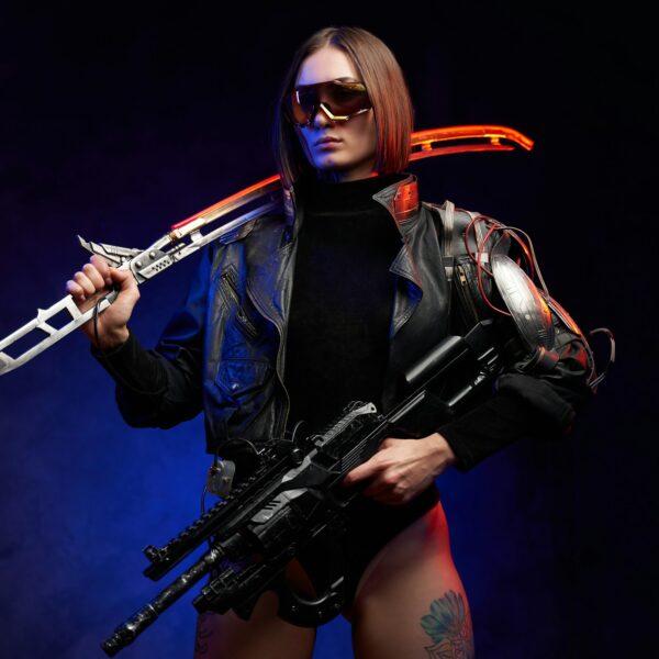 Female killer with sword and rifle in colourful and dark background